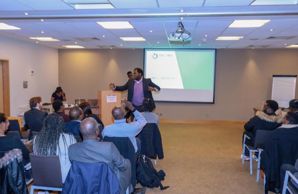 Ayo Akande speaking with an audience at a Cee4Bee evening event